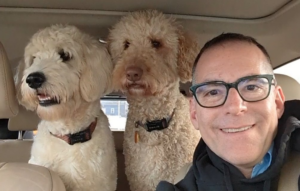 Robert Weinerman headshot with two dogs